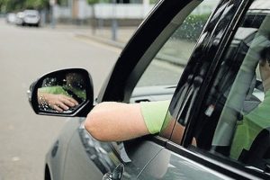 photo of Man Driving Arm out the Window